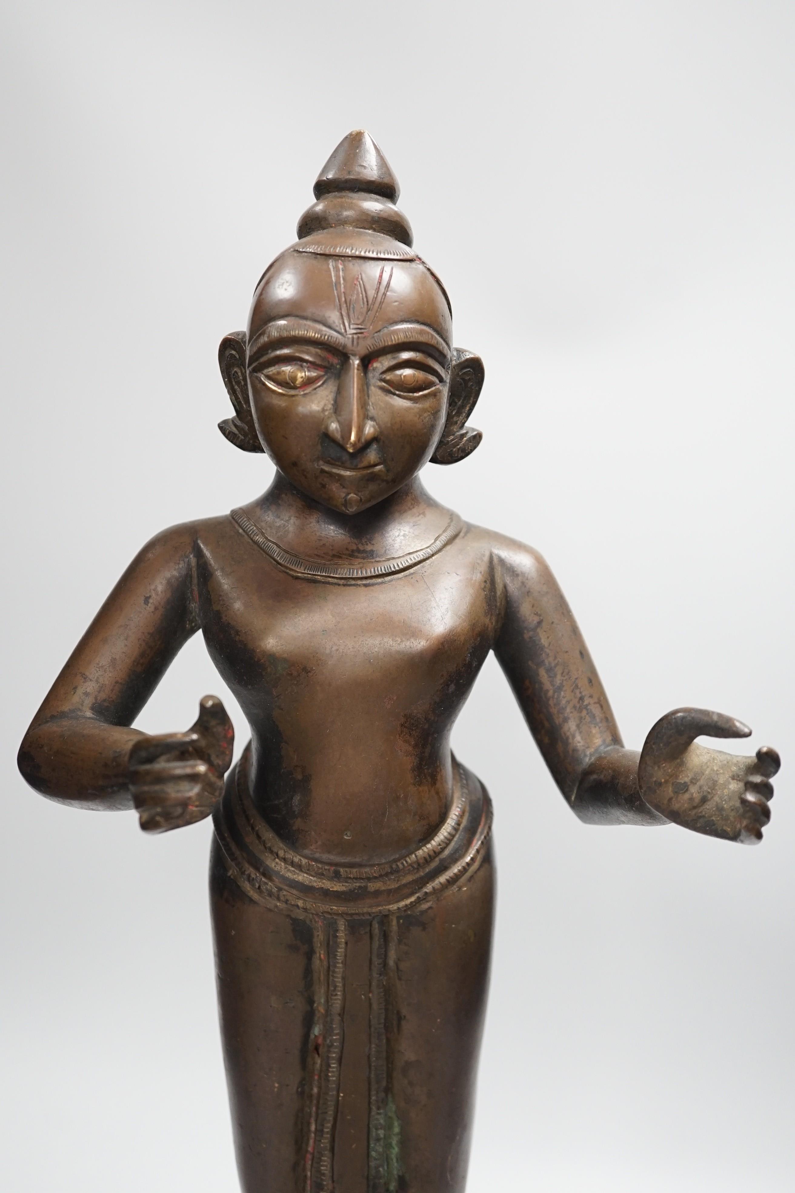 A large and heavy 19th century Indian bronze figure of Radha with separate bronze pedestal, total height 56cm